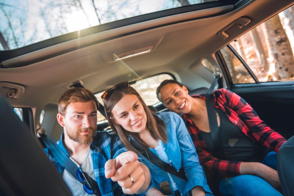 Happy friends on back seat of a car