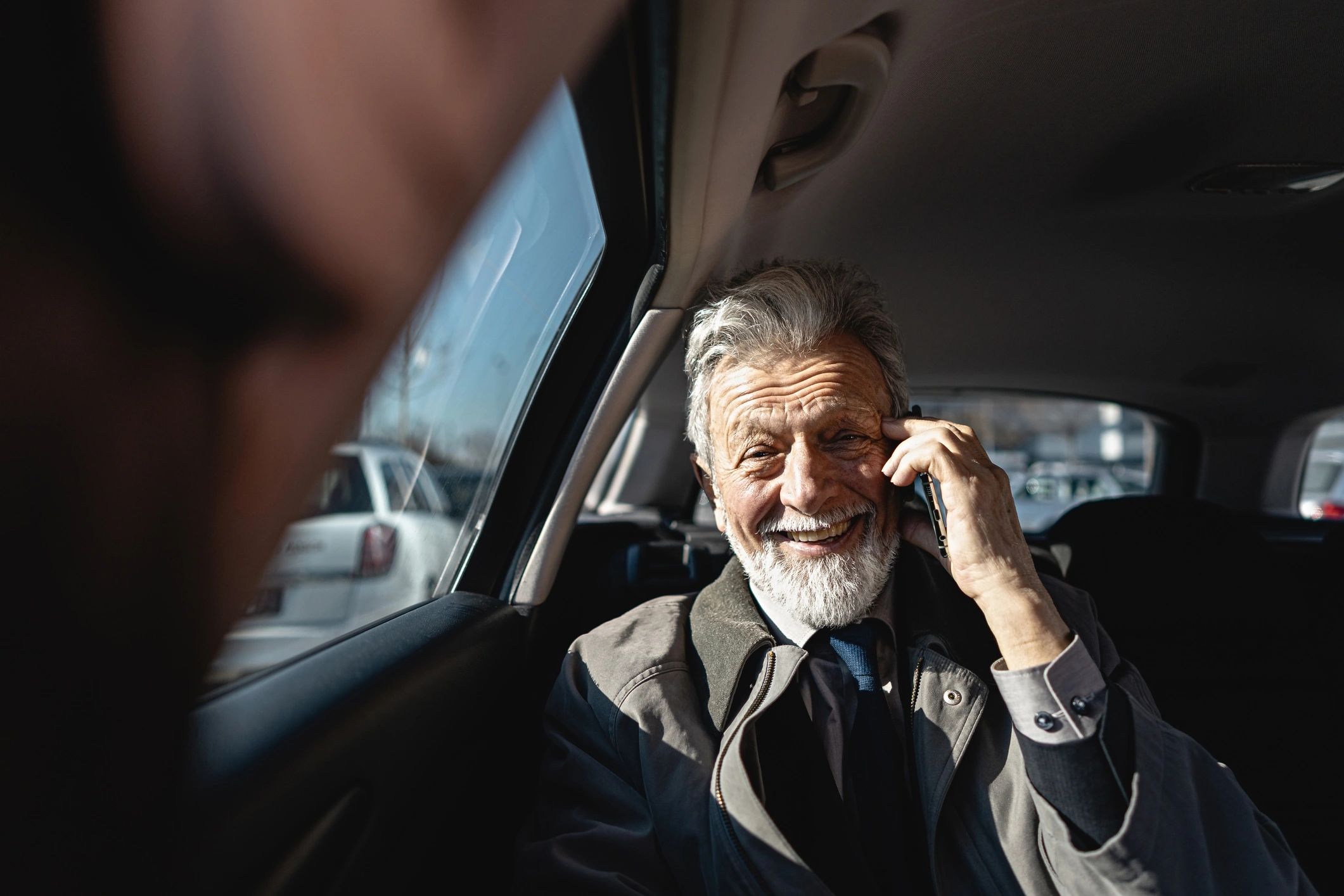 Business traveler inside a chauffeured car