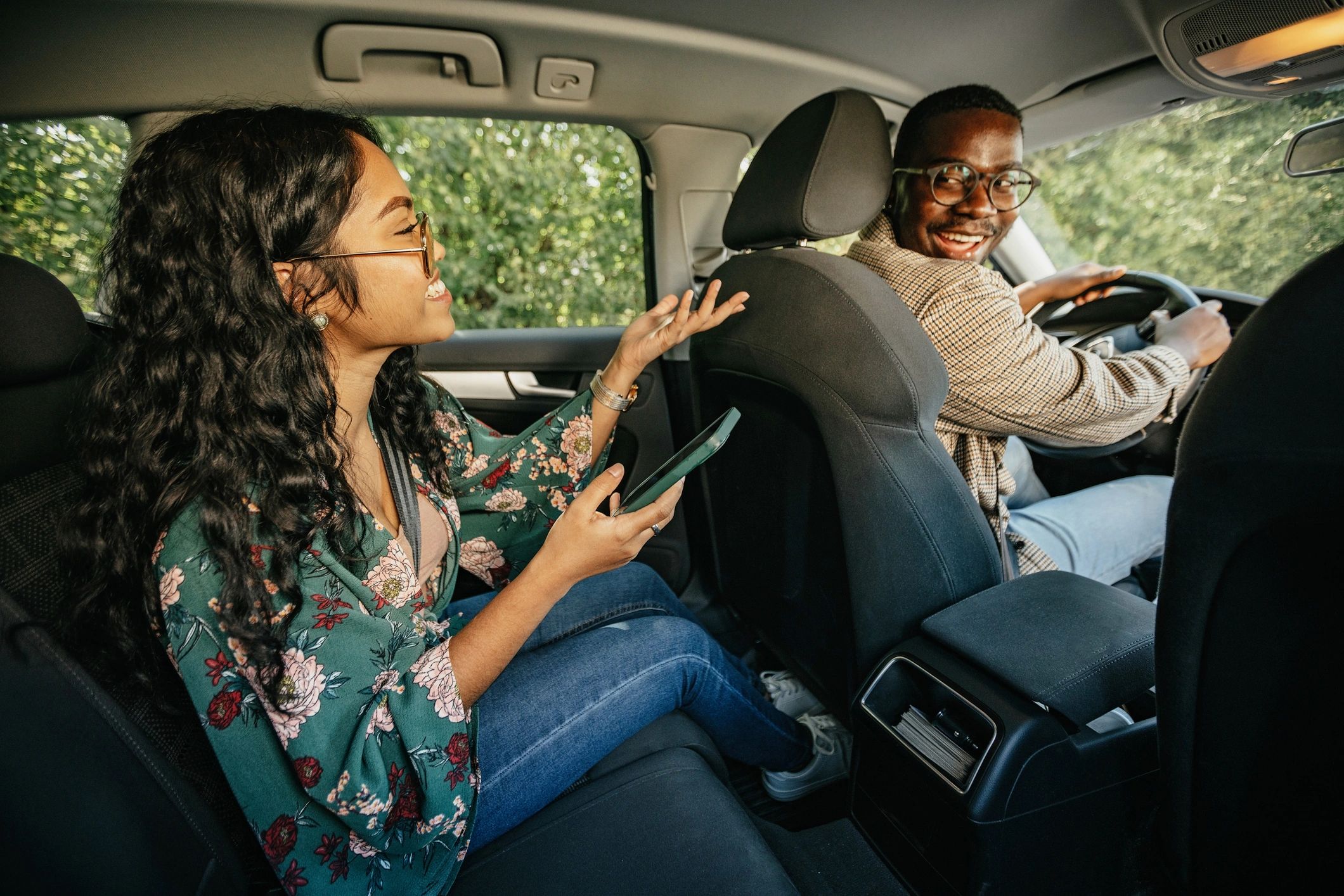 Happy passenger speaking with driver